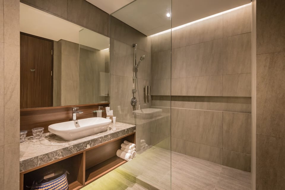 Deluxe Double Room (Free Self Service Laundry) | Bathroom | Shower, slippers, towels, soap