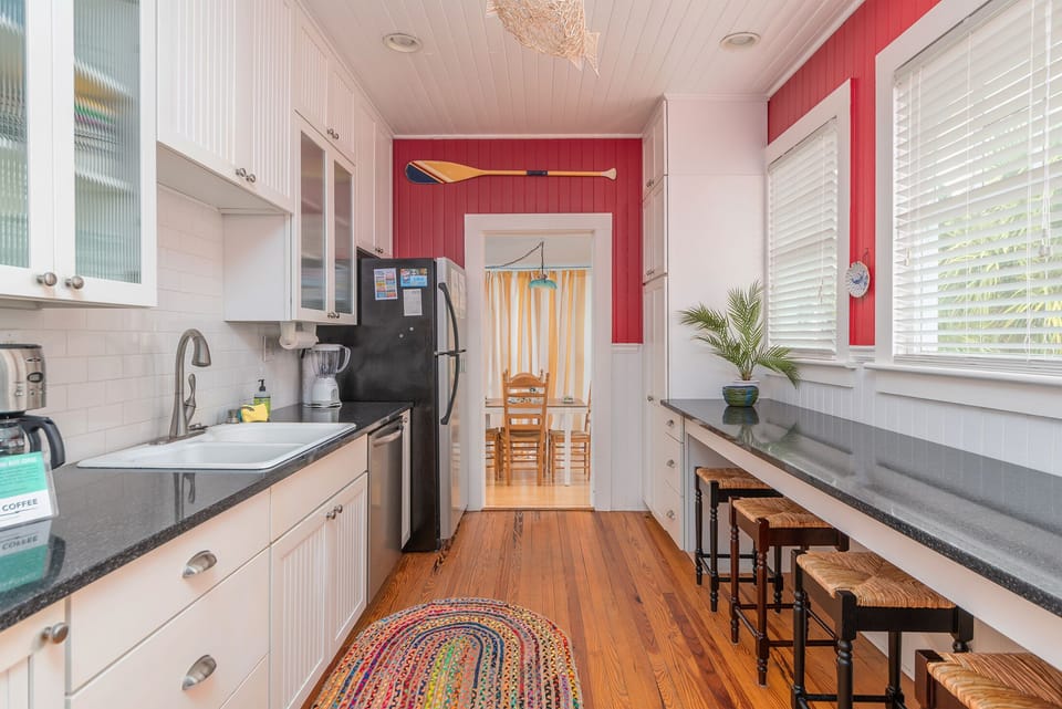 Galley Kitchen - Modern clean and sophisticated kitchen with seating under the bright windows.