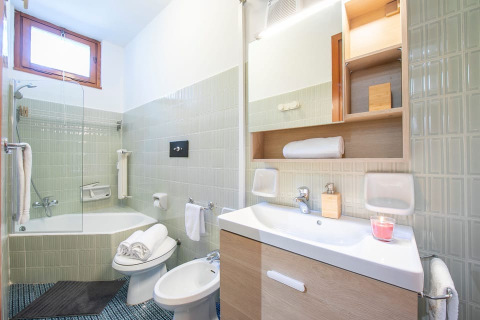 Family Apartment, Multiple Bedrooms (Il Nido Nella Pineta) | Bathroom | Combined shower/tub, hair dryer, bidet, towels
