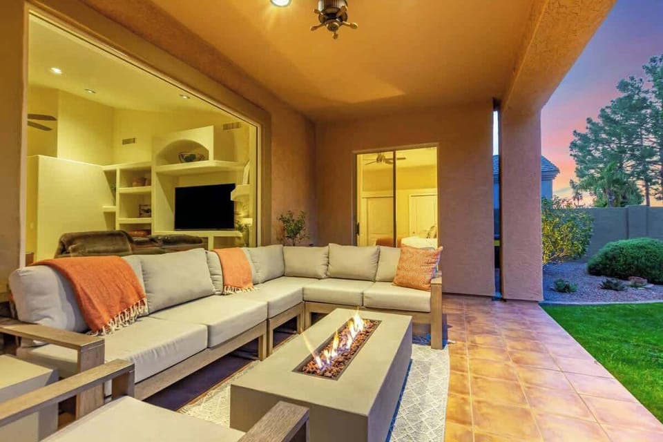 Covered Patio with plenty of seating and a cozy firetable feature