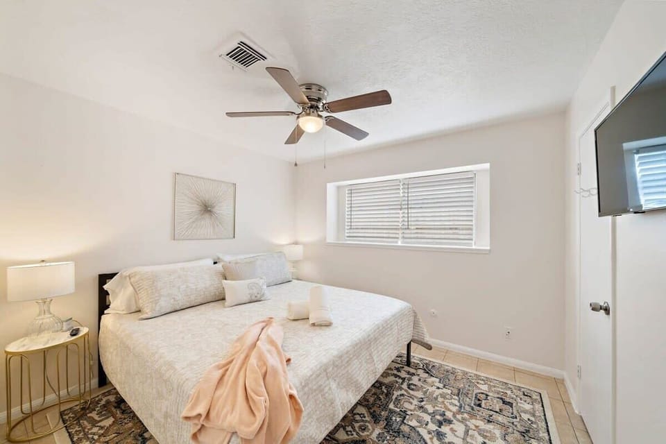 Guest Bedroom: Bright and inviting with stylish decor and a comfy bed for a perfect night's sleep.