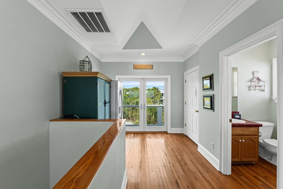 Step into your serene kitchen space with warm hardwood floors and elegant sage walls that create the perfect backdrop for your culinary adventures.
