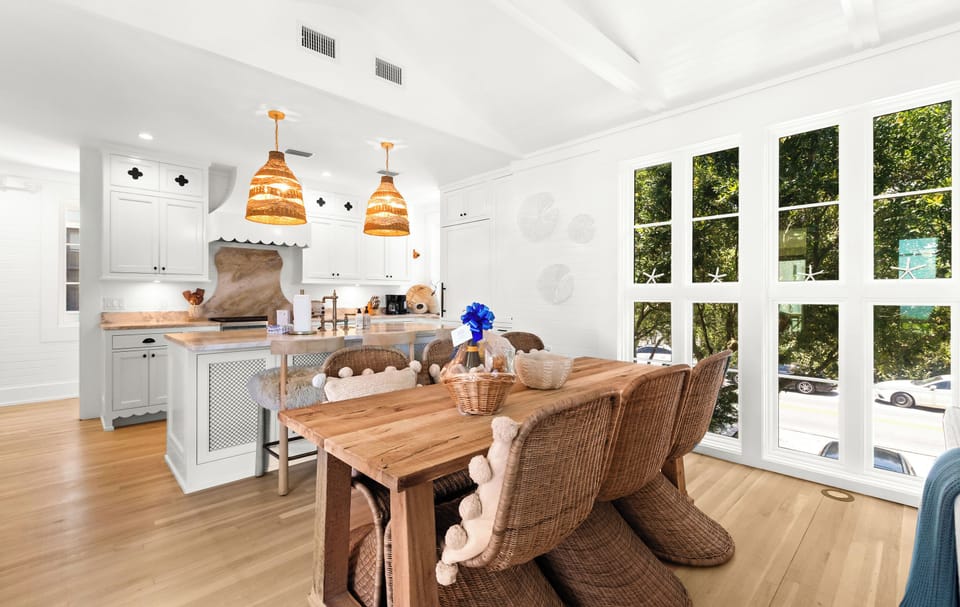 Your bright, open kitchen and dining area invites you to gather around the rustic wood table, cook a meal with friends, and enjoy sunlight streaming through the large windows