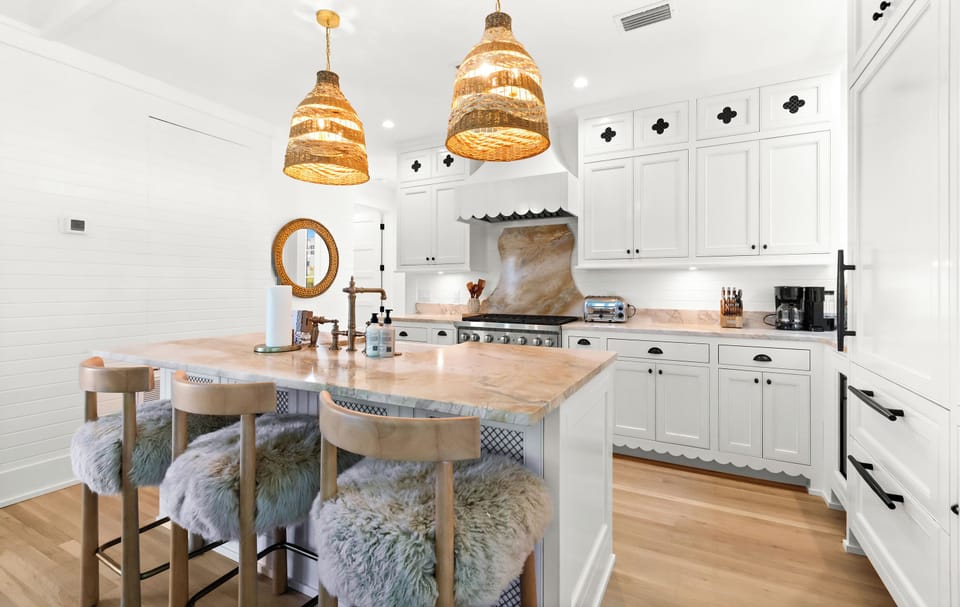 Your dream kitchen awaits, bathed in natural light with a spacious marble island, plush seating, and a professional-grade range ready for your culinary adventures.