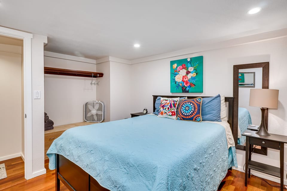Second downstairs bedroom includes queen bed and open closet. 