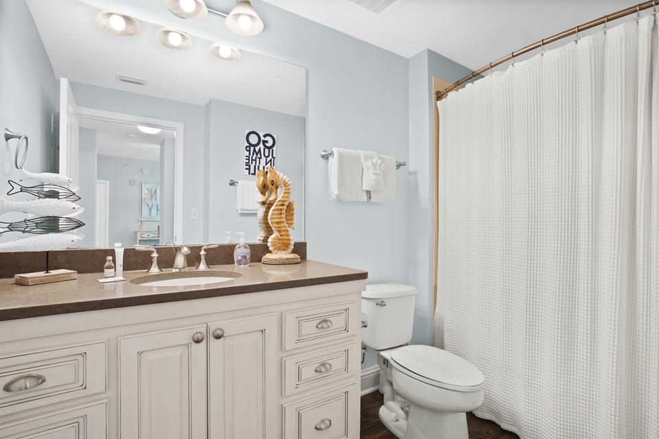 Your private coastal bathroom features spa-like lighting, quality linens, and charming nautical touches that make your morning routine feel like a mini vacation.