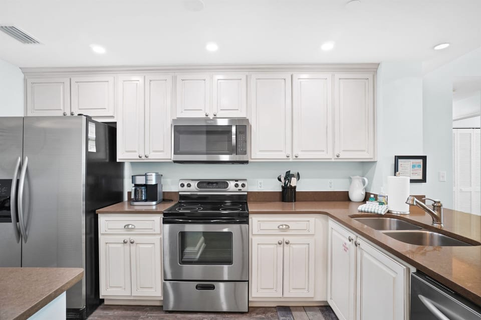 Your fully equipped kitchen awaits with stainless steel appliances and warm wood countertops for memorable meal prep.