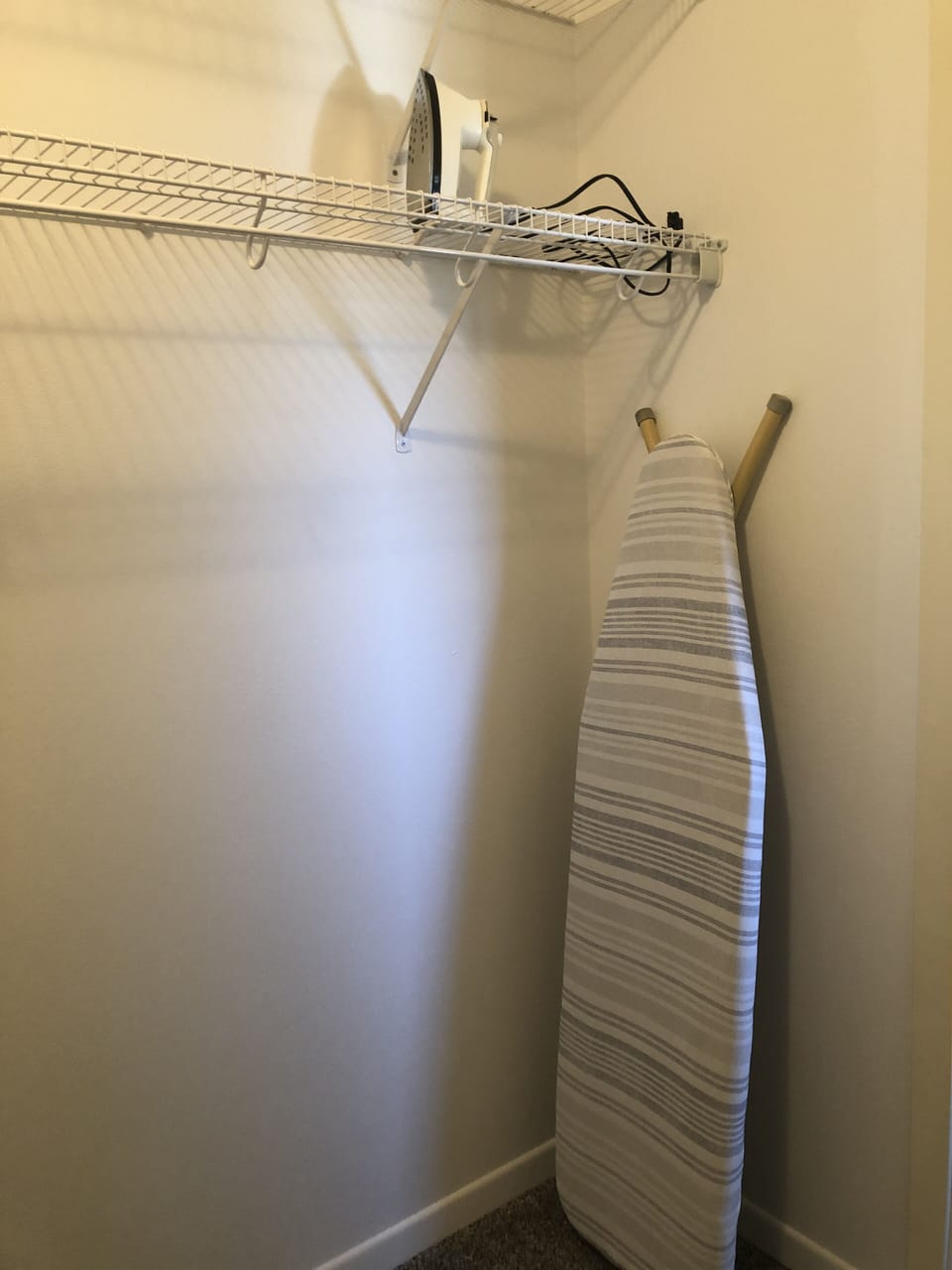 Iron and ironing board in master closet