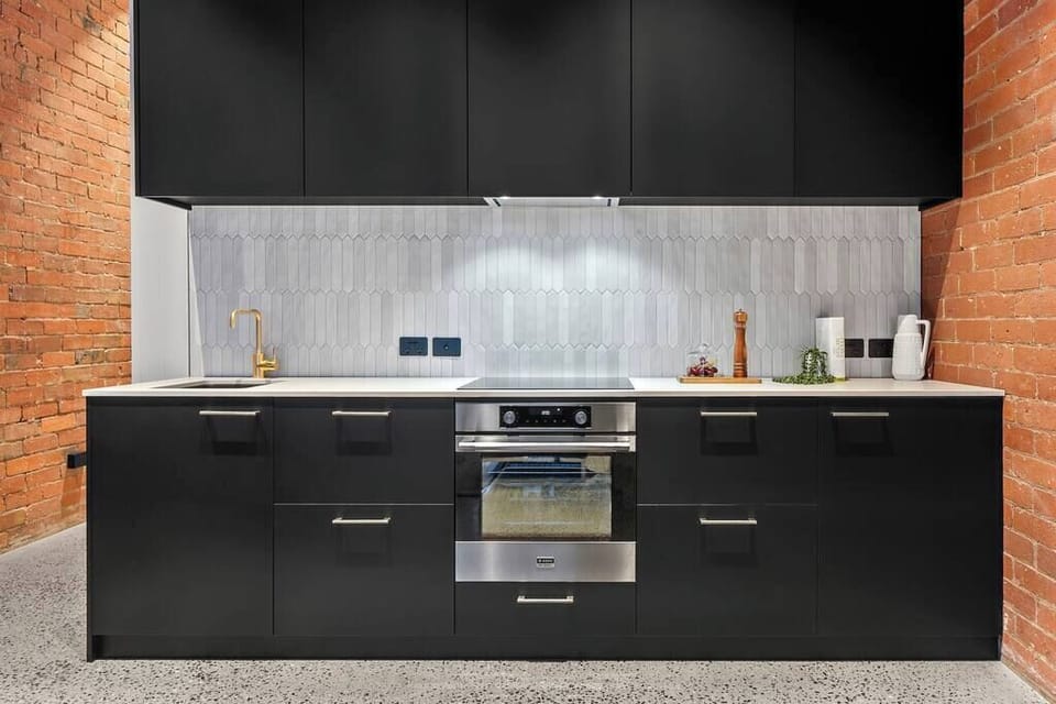 Kitchen with mini fridge, dishwasher, oven & stovetop