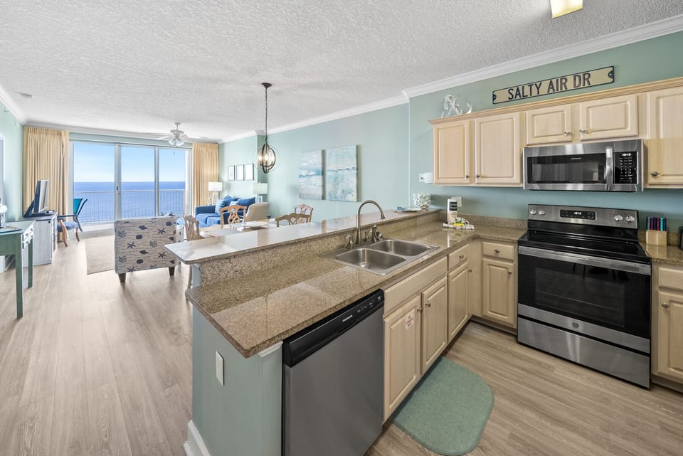 Your fully equipped kitchen opens to stunning ocean views, where you'll enjoy cooking with modern appliances while watching waves dance beyond the windows.