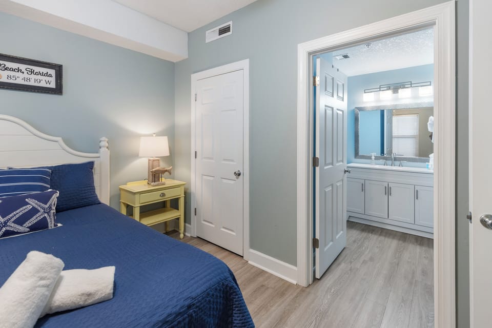 Your coastal bedroom features nautical blues, soft linens, and an en-suite bathroom for complete privacy and comfort.
