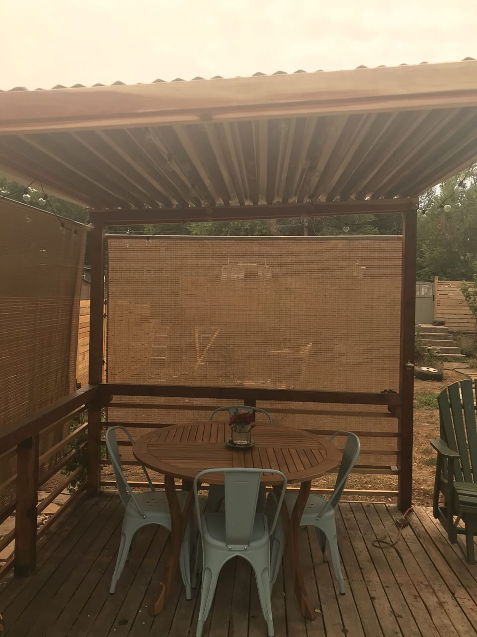 Backyard patio space- retractable blinds to shield the sun. Twinkle lights