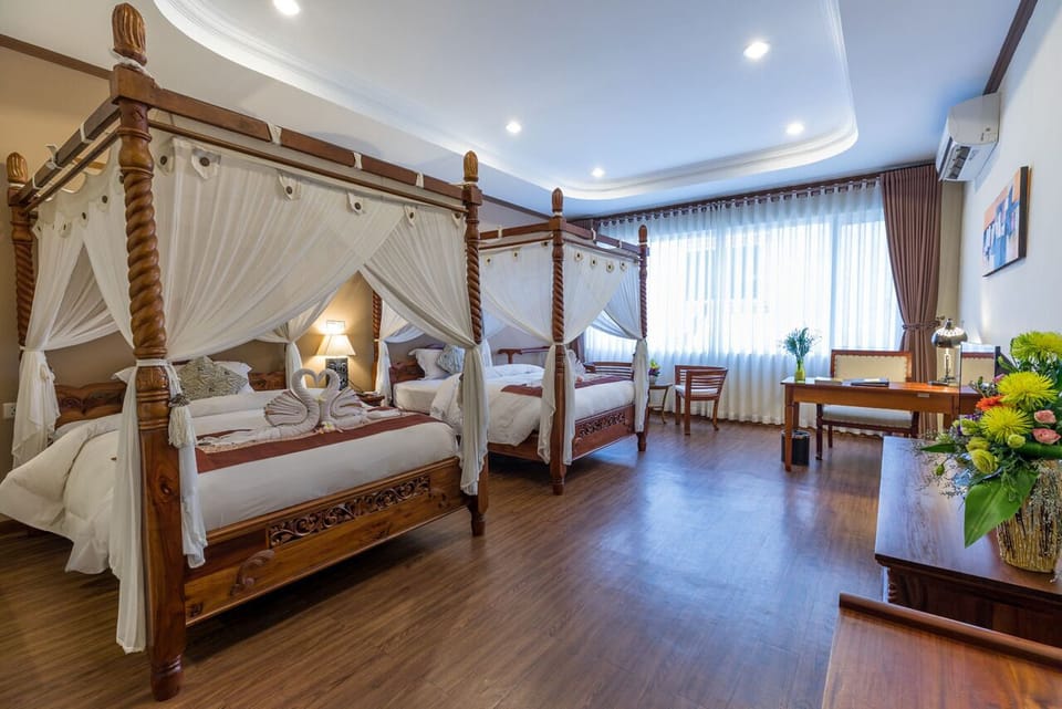 Deluxe Twin Room | Minibar, in-room safe, individually decorated, blackout drapes