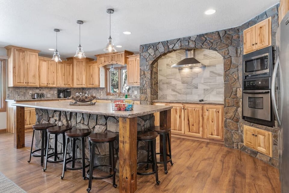 Large Kitchen Counter Top With Six Bar Stools.