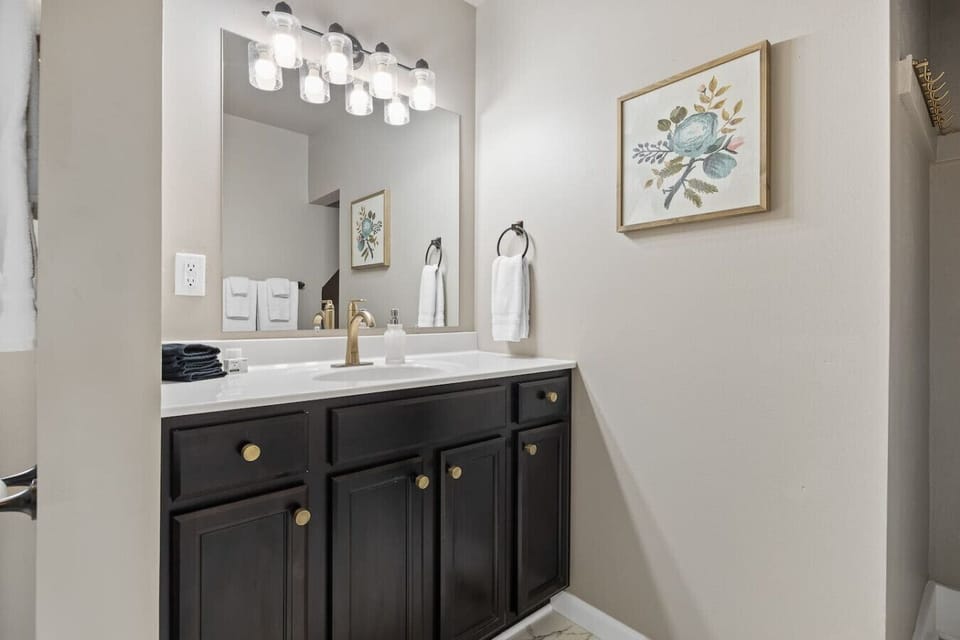 Spacious bathroom with a large vanity mirror, providing ample space for your daily routine.