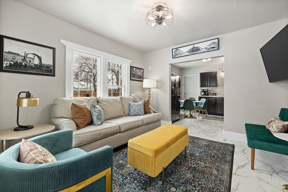 Cozy living room featuring a loveseat, couch, and a pullout sofa, beautifully arranged with tasteful décor for a welcoming ambiance.