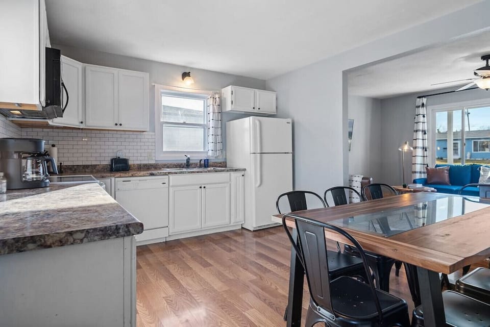 Large open kitchen with dishes, pans, coffee, coffee maker, stove, and everything you need during your stay!