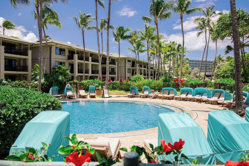 Resort-style pool with lush gardens and plenty of lounge seating!