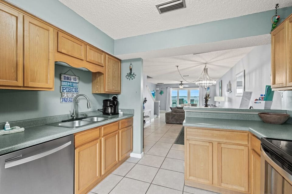 Complete kitchen setup featuring an electric range, stove, dishwasher, fridge-freezer with ice maker, and Keurig coffee machine