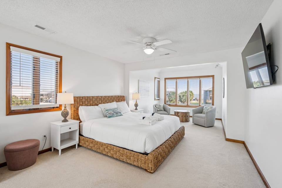 Spacious primary bedroom with a king bed, additional twin bed, and smart TV for your comfort and convenience.
