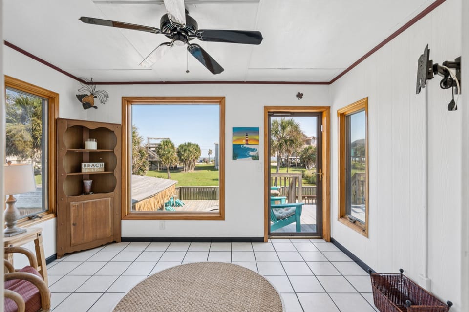 Soak up the sunshine in the cozy sunroom overlooking the pool and back deck