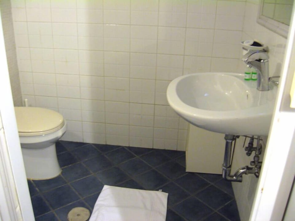 Shower, hair dryer, slippers, towels