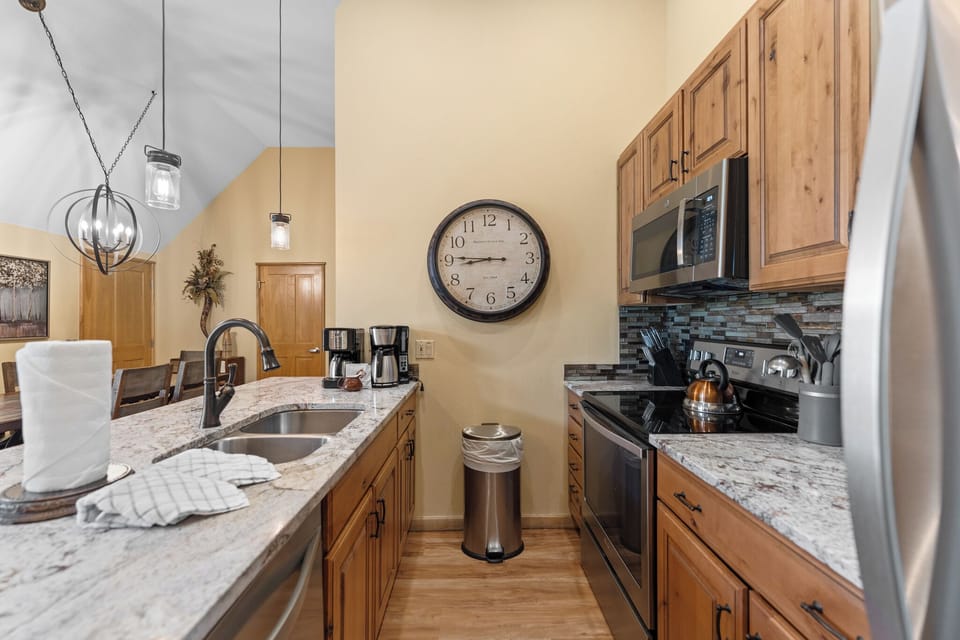 Step into your fully equipped kitchen with granite counters, stainless appliances, and rustic wood cabinets—perfect for preparing memorable meals together.