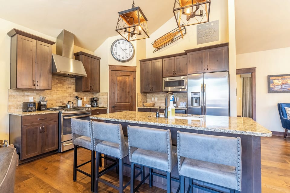 Your gourmet kitchen features granite countertops, stainless steel appliances, and a spacious island perfect for cooking memorable meals together.