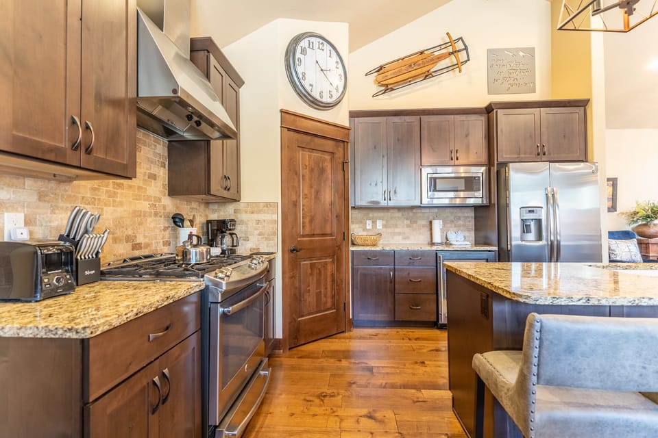 Full-sized kitchen featuring granite countertops, stainless steel appliances, and brand new light fixtures.
