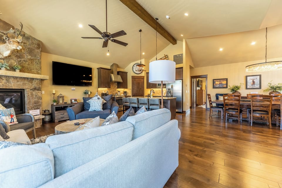 Relax in this stunning open-concept living space where rustic charm meets modern comfort, perfect for your mountain getaway.