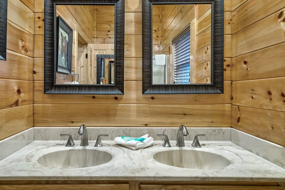 The 'Glam Room' ensuite bath features a tub shower combination.
