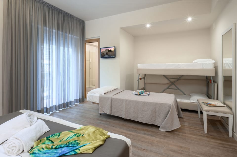 Family Quadruple Room | In-room safe, desk, free WiFi, bed sheets