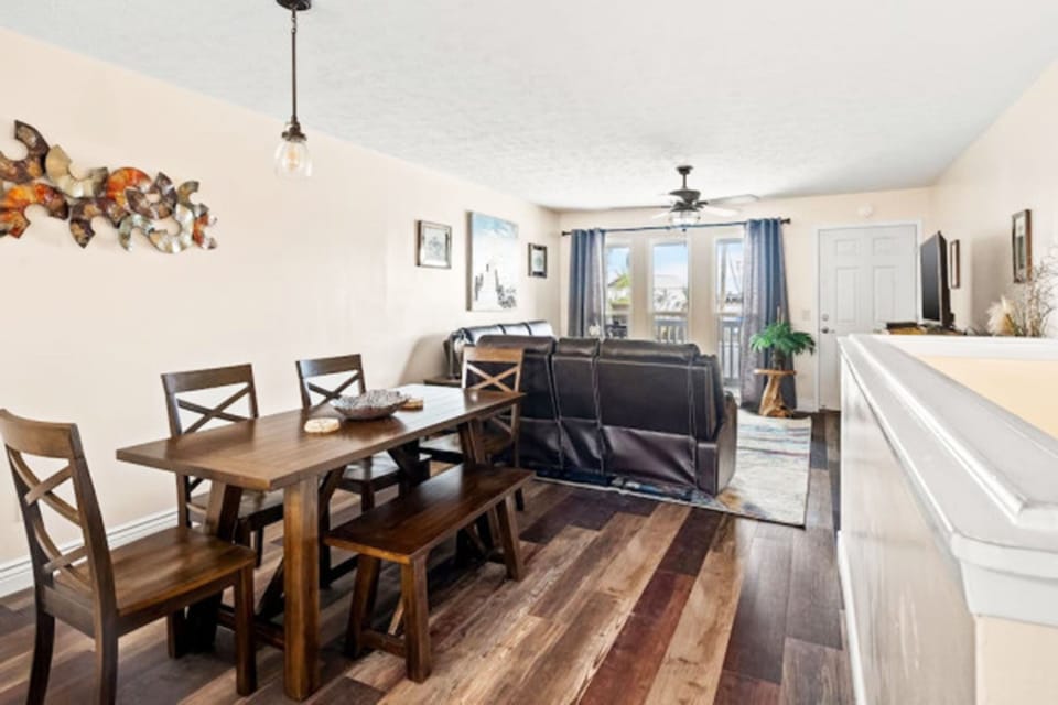 The dining room features a spacious table with seating for six, making it the perfect spot for family meals, game nights, or casual gatherings.