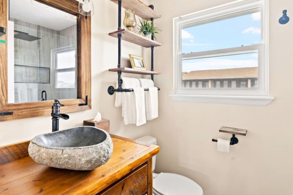 The guest bathroom offers a shower and tub combination, providing flexibility for both quick rinses and relaxing soaks.