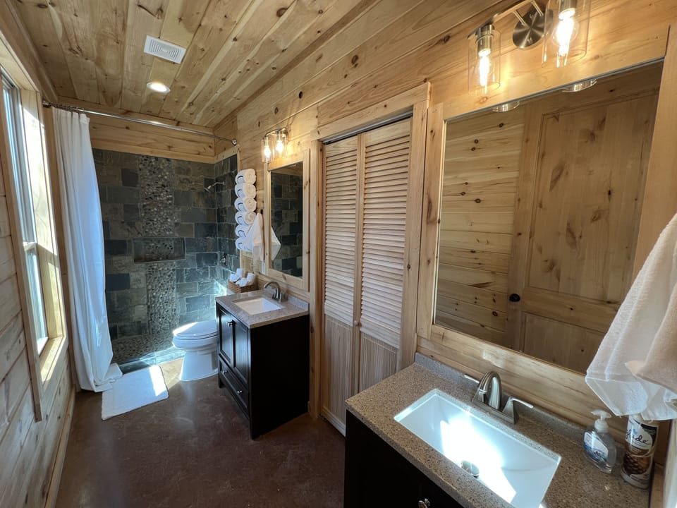 Master bath, tiled walk-in shower, his and hers sink.
