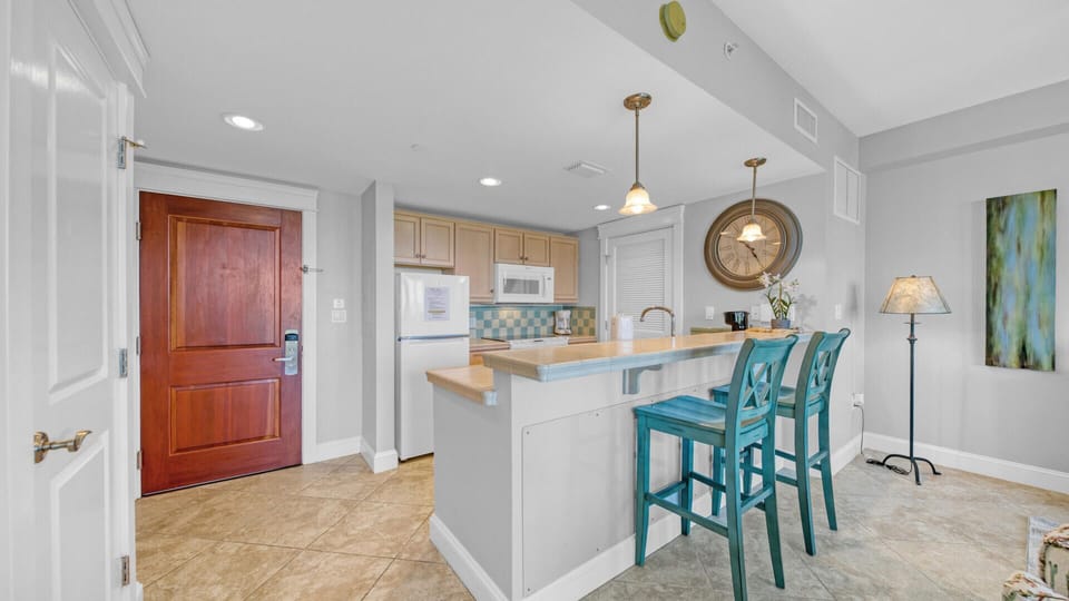 Kitchen . Bar with two stools.