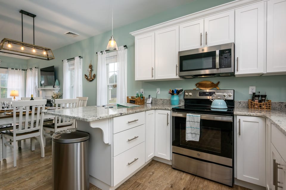 Fully equipped kitchen with stainless steel appliances.