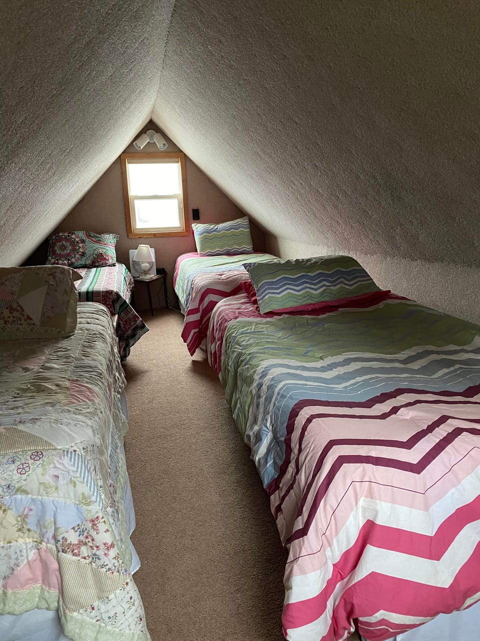 Upstairs room with 4 twin beds and window a/c unit