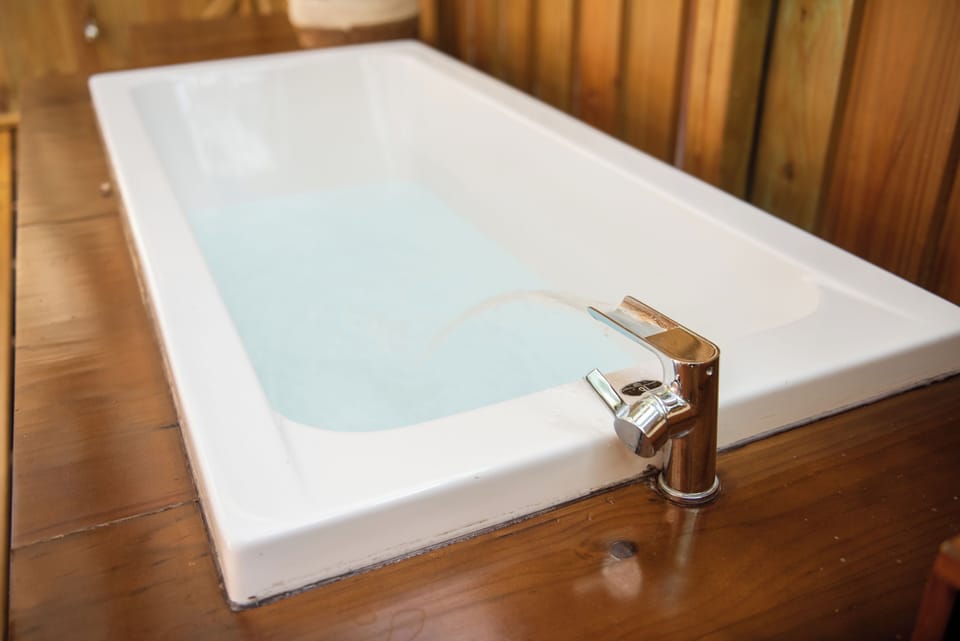 Separate tub and shower, rainfall showerhead, towels, soap