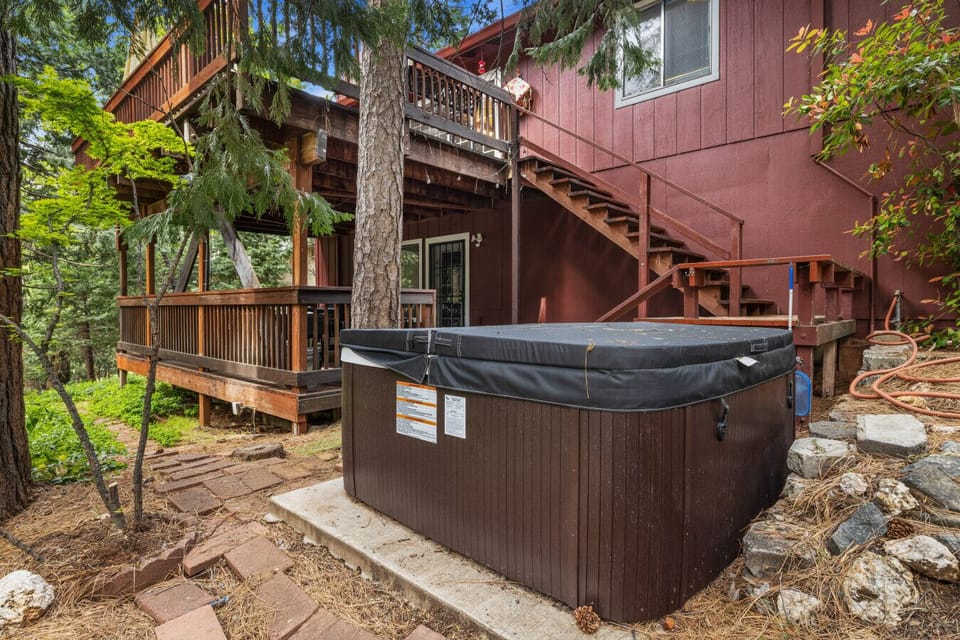 Unwind in our secluded outdoor hot tub surrounded by serene woodland view