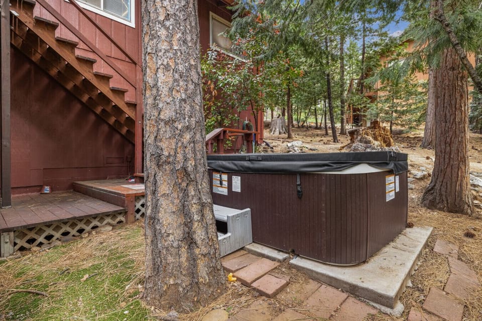 Unwind in our secluded outdoor hot tub surrounded by serene woodland view
