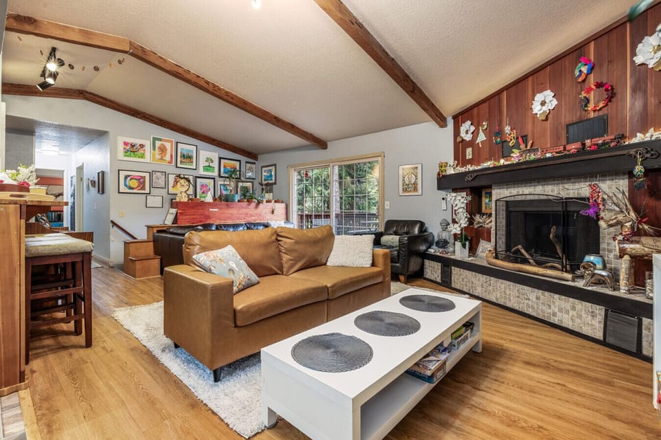 Deep leather seating, a traditional fireplace, and views of the woods: the ultimate cozy retreat.