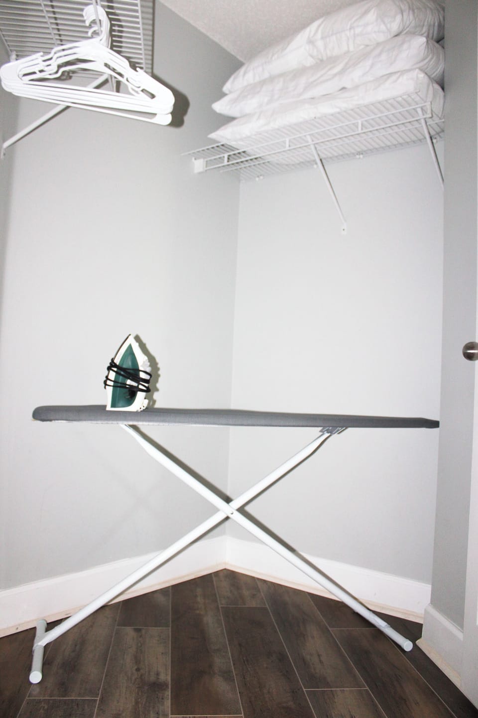 In case you need to get the wrinkles out of your favorite shirt, a standard iron and ironing board are neatly tucked away in the laundry area for your use.