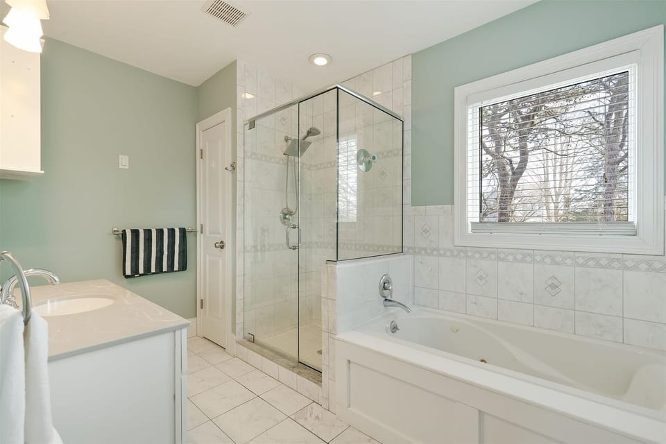 Full bathroom with separate tub area