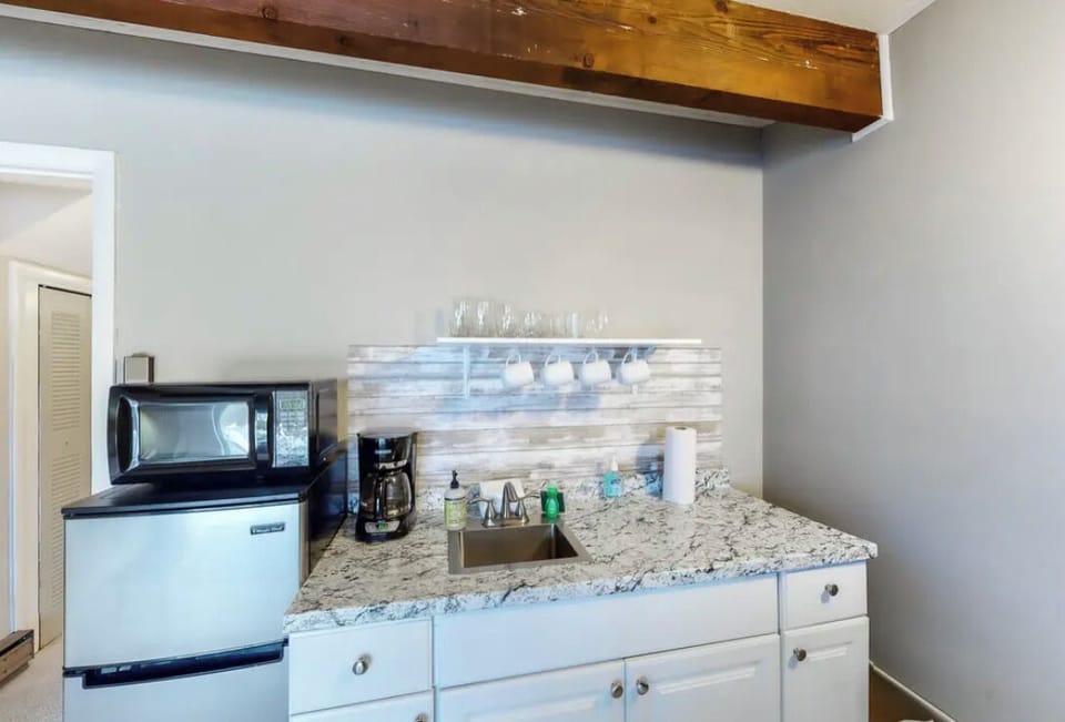 Downstairs kitchenette: Refrigerator, sink, hotplate, microwave, coffee maker