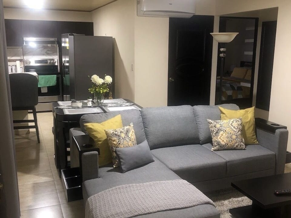 Deluxe Apartment, 2 Bedrooms, Air conditioning (Entire Two-Bedroom Apartment for 4) | Living area | 55-inch Smart TV with cable channels, TV
