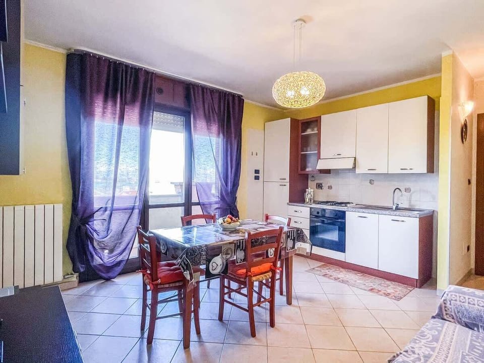 Living room with kitchenette, sofa bed and flat screen TV. Large balcony from which you can also see the Basilica of Superga