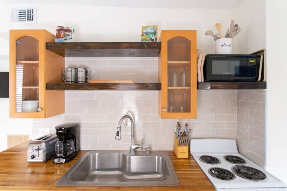 Kitchen includes refrigerator, oven, stove top, toaster, microwave, and drip coffee maker