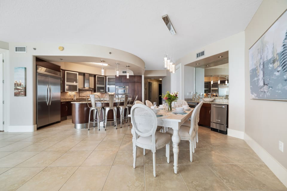 Exquisite details abound in this high-end kitchen, from the frosted glass cabinetry to the professional-grade appliances. Experience luxury in every culinary creation.