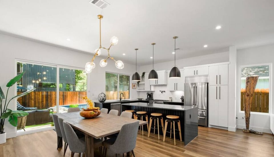Large kitchen and dining room with slider door leading to the backyard